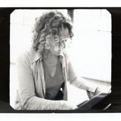 Carole plays piano.  Photo by Jim Wright