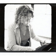 Carole plays piano.  Photo by Jim Wright